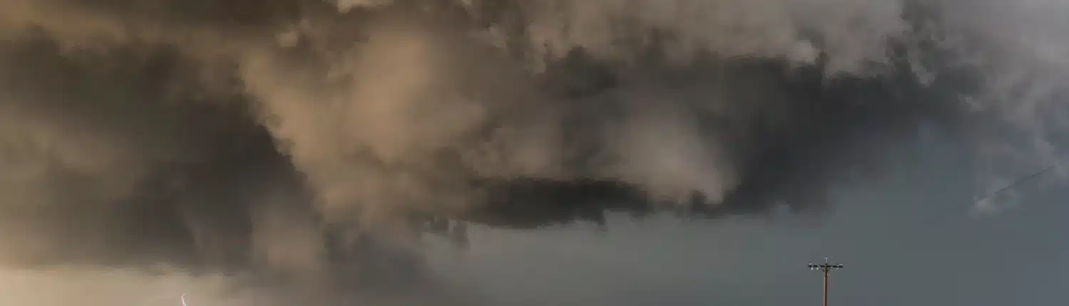 storm-clouds-loom-over-a-green-field-with-lightnin-2025-04-03-21-31-36-utc