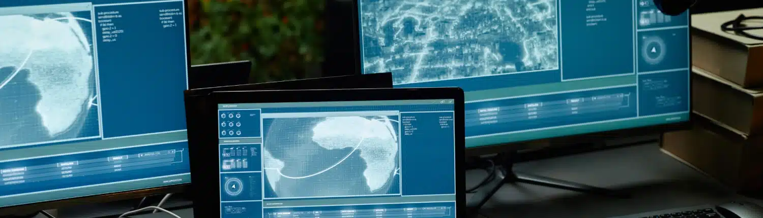 two-computer-monitors-and-laptop-with-information-2025-03-07-15-17-57-utc